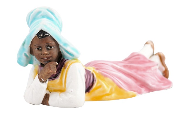 Petite English Porcelain Figurine Depicting a Young Girl Laying on the Ground