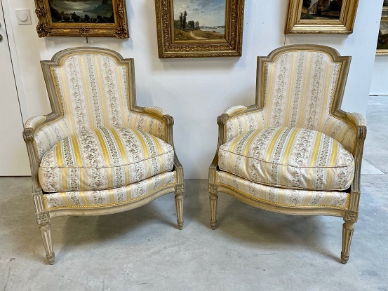 SOLD:  Pair of French Louis XVI Style Bergères Chairs with Fluted Legs and Rosettes